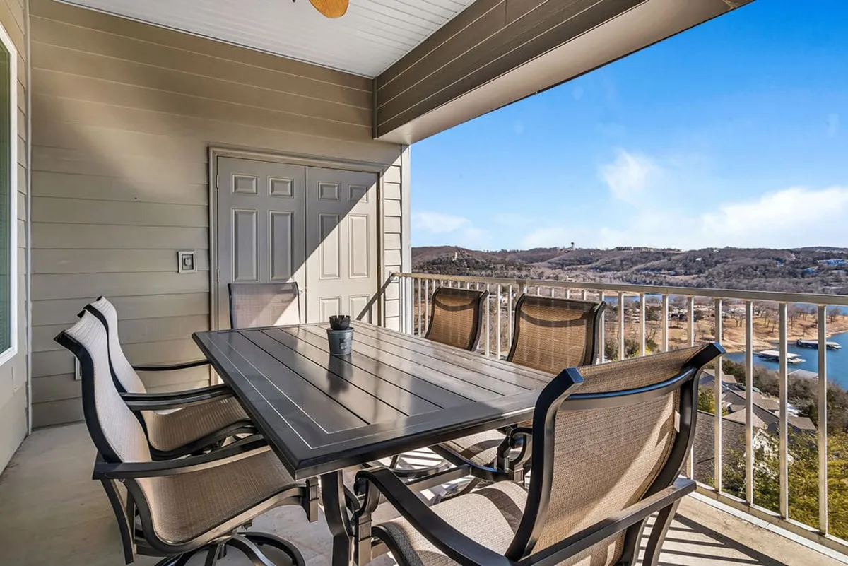 An inviting exterior scene featuring an outdoor dining table and chairs set on a private deck, overlooking scenic views. This spot is ideal for al fresco family meals and gatherings, with space for everyone to connect in the fresh air.